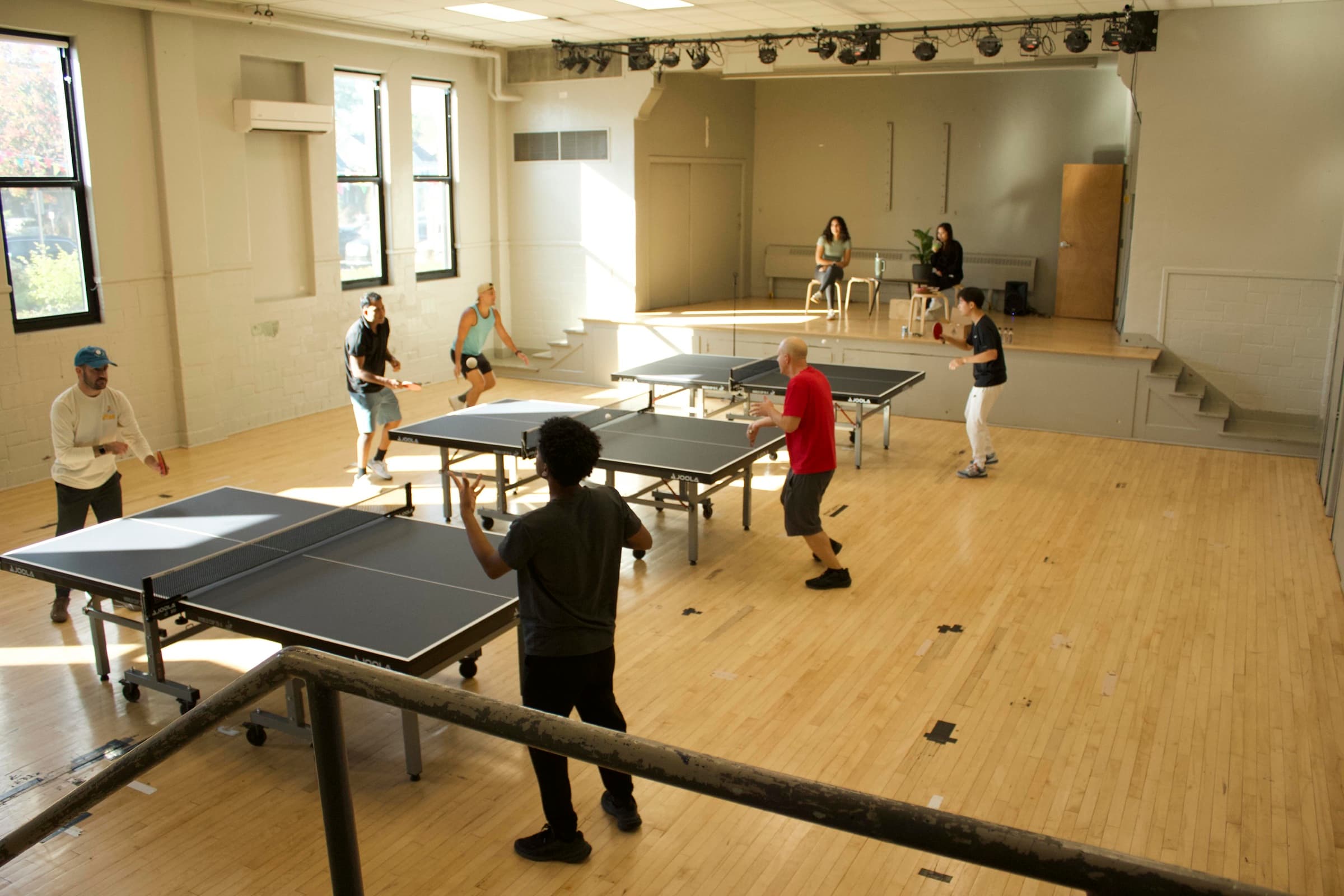 Players enjoying table tennis together at Plymouth Ping Pong