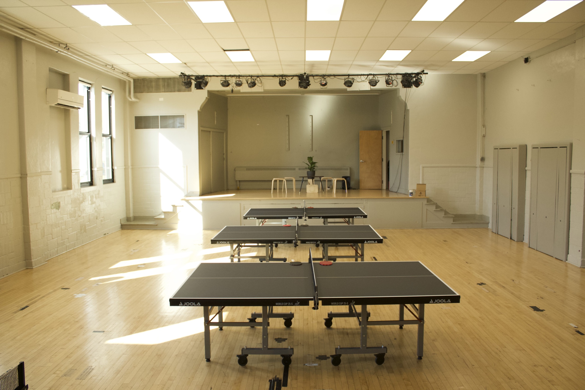 Three table tennis tables set up inside the Plymouth Ping Pong gym